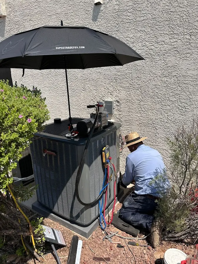 HVAC technician performing outdoor AC maintenance in Prior Lake